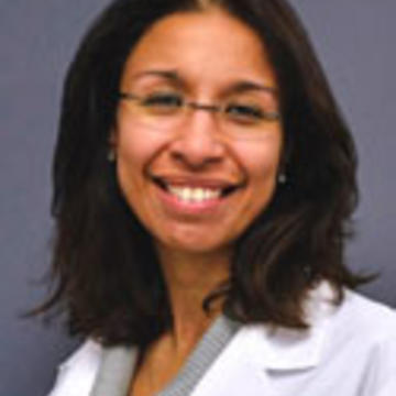 Nina smiles in glasses and her white medical coat