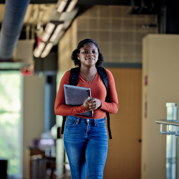 a student walking inside saint joseph's university's post commons library