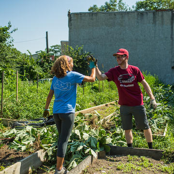 students high five at a service site