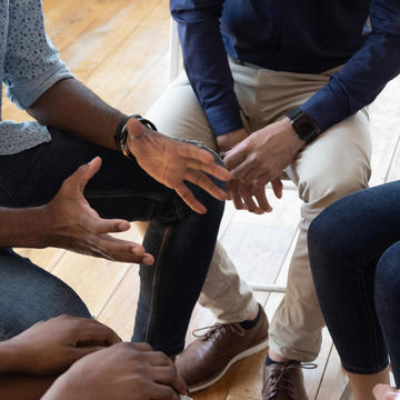 close up of support group sitting in a circle