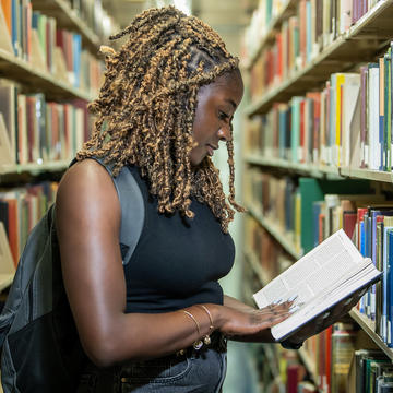 a student reading a book in the library