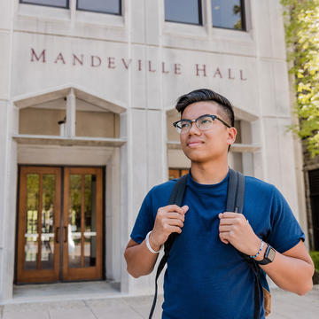 male saint joseph's university student walking outside mandeville hall