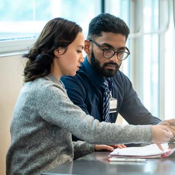 two graduate students doing school work at saint joseph's university