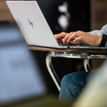 Student typing on a computer