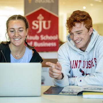 Two business majors in Mandeville Hall at Saint Joseph's University