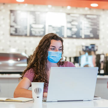 Student sitting in dining hall