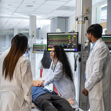 three pharmacy assistant students inside a simulation lab at Saint Joseph's University