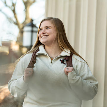 Smiling Saint Joseph's University student walking on campus