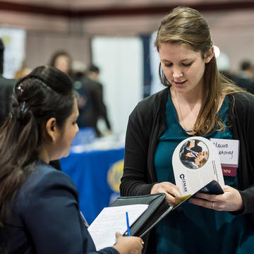 a student talking to a potential employer during a career fair