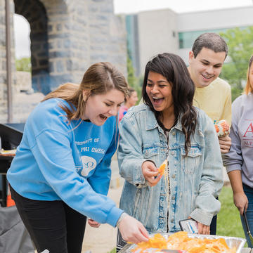 students eating chips at an event