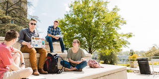 Saint Joseph's Students sitting on the steps out side the Drexel Library at Saint Joseph's University Campus