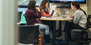 three saint joseph's university students doing work in the communications lab