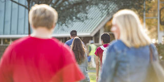 group of five students headed to class