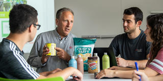 food marketing professor holding a can and pointing at a label