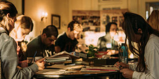 Students sitting around a table studying