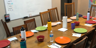 A table set with colorful dinner plates and glasses