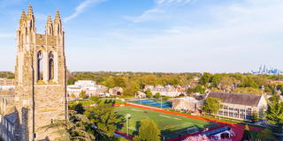 Aerial view of Saint Joseph's University campus with Barbelin tower and Sweeney field with Philadelphia skyline in the background