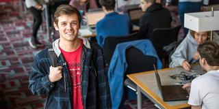 Saint Joseph's University admitted student in standing in library