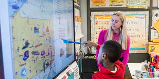 Student teacher teaching children in a classroom