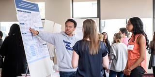 Male Saint Joseph's student presenting his research at symposium