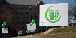 Banner with SJU Green Dot logo on a lawn on SJU's campus
