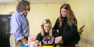Saint Joseph's occupational therapy student helping patient use spoon