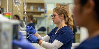 Saint Joseph's University nursing student working on an IV.
