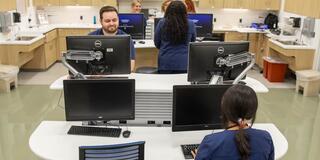 Students working from computers at the nursing station