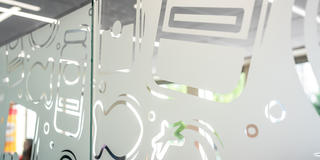 Campbells collection wall that has illustrations etched in glass.