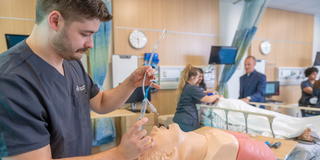 Saint Joseph's University in Lancaster student working on a model in a clinical lab setting