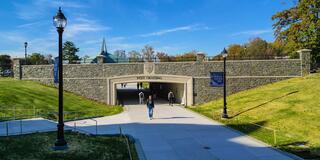 Students walking under Post Crossing at Saint Joseph's University