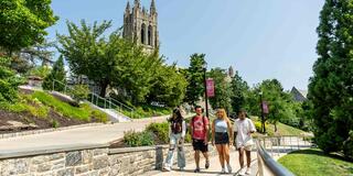 Group of 4 students walking outside on Saint Joseph's University Hawk Hill Location