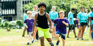 Saint Joseph's Kinney Center teachers outside with students for camp