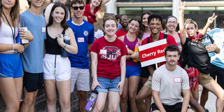 orientation groups smiling for photo