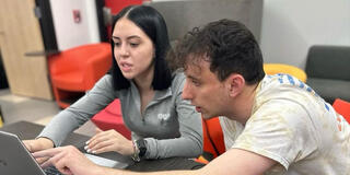 Weekly Service volunteers looking at a computer
