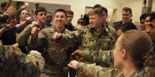 Air Force ROTC members fist bumping wearing cammos