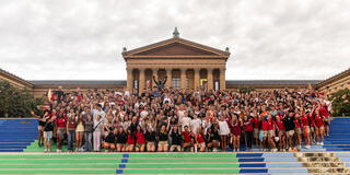 Students Smiling at Photo on Rocky Steps