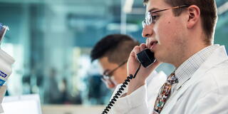 Pharmacy students, with one on the telephone