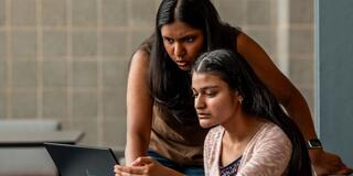 McNulty Fellows_Rachel Vemula and Jiya Patel_Looking at a laptop_2400x1450