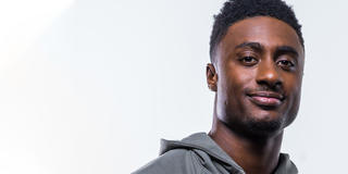 Toliver looks directly at the camera in a close-up