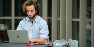 Student studying on laptop outside Post