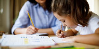 Child studying and writing.