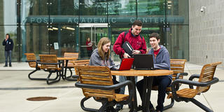 three students talking on saint joseph's university campus