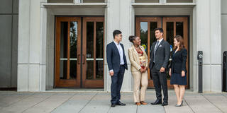 four saint joseph's university business students standing outside mandeville hall