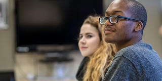 two saint joseph's university students inside a classroom