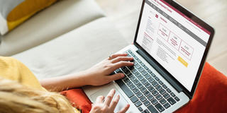 student's hands on a laptop keyboard