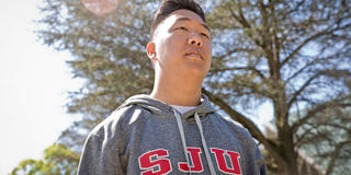 male saint joseph's student walking outside