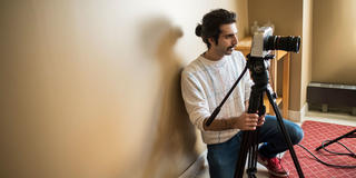 male saint joseph's university students holding a video camera