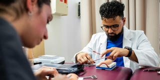 physician assistant student during a suturing lab