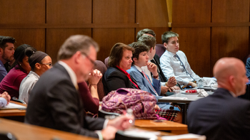 Participants and judges sit in Mandeville Hall's Teletorium during the High School Investment Competition